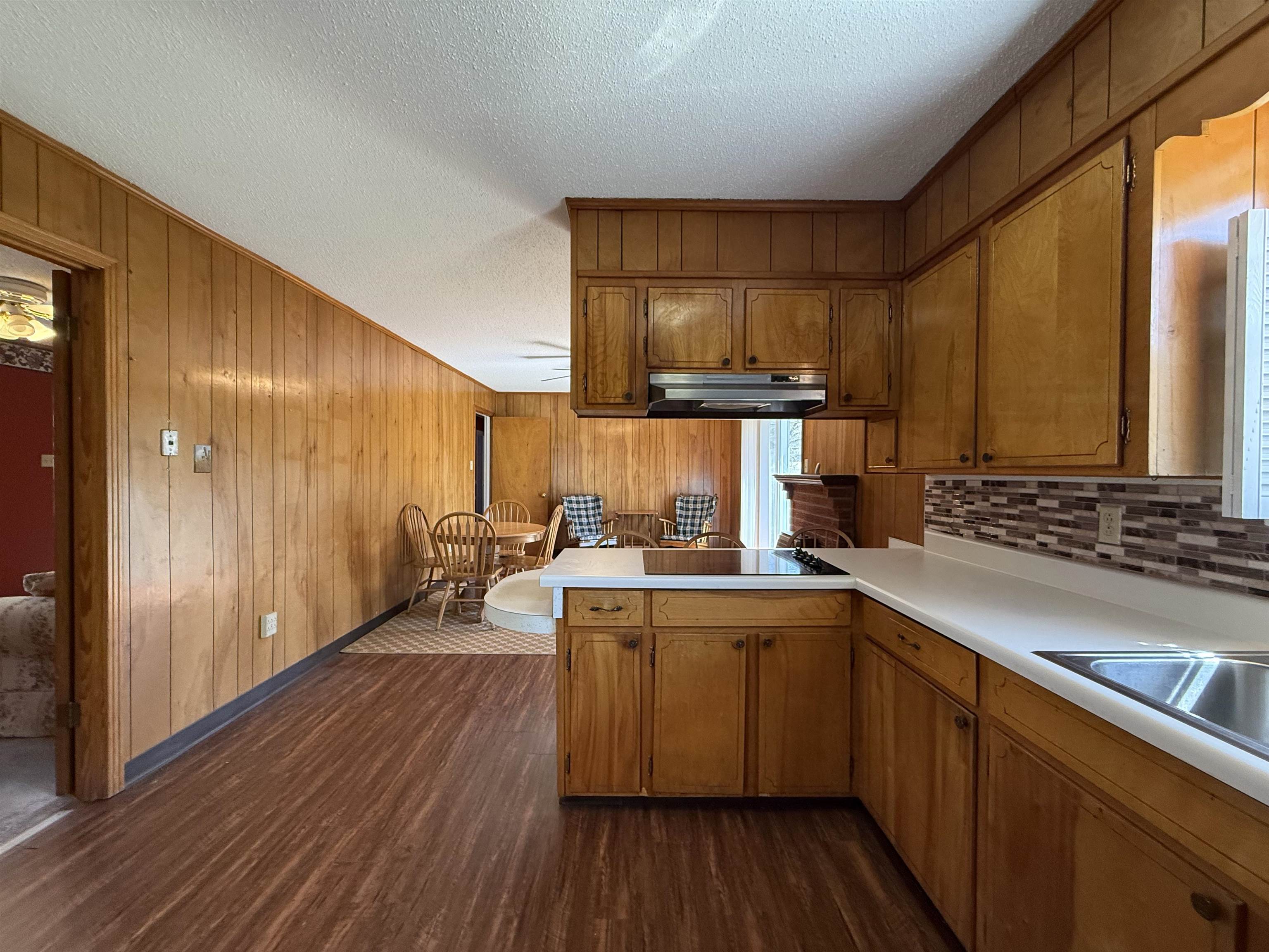 115 Robertson Drive Somerville, TN 38068 - Photo 8 of 19 a kitchen with sink cabinets and wooden floor
