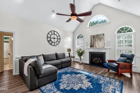 a living room with furniture a chandelier and a fireplace