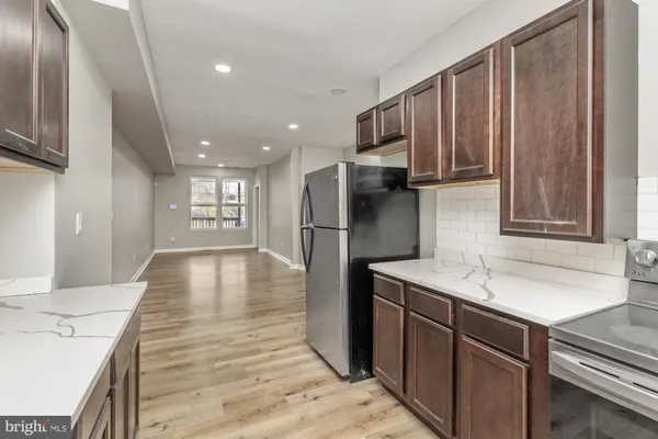 a kitchen with stainless steel appliances granite countertop a refrigerator sink and cabinets