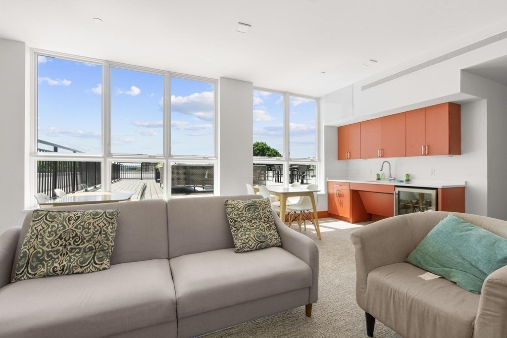 3531 Washington Street, Unit 203 Boston, MA 02130 - Photo 13 of 17 a living room with furniture and a fireplace