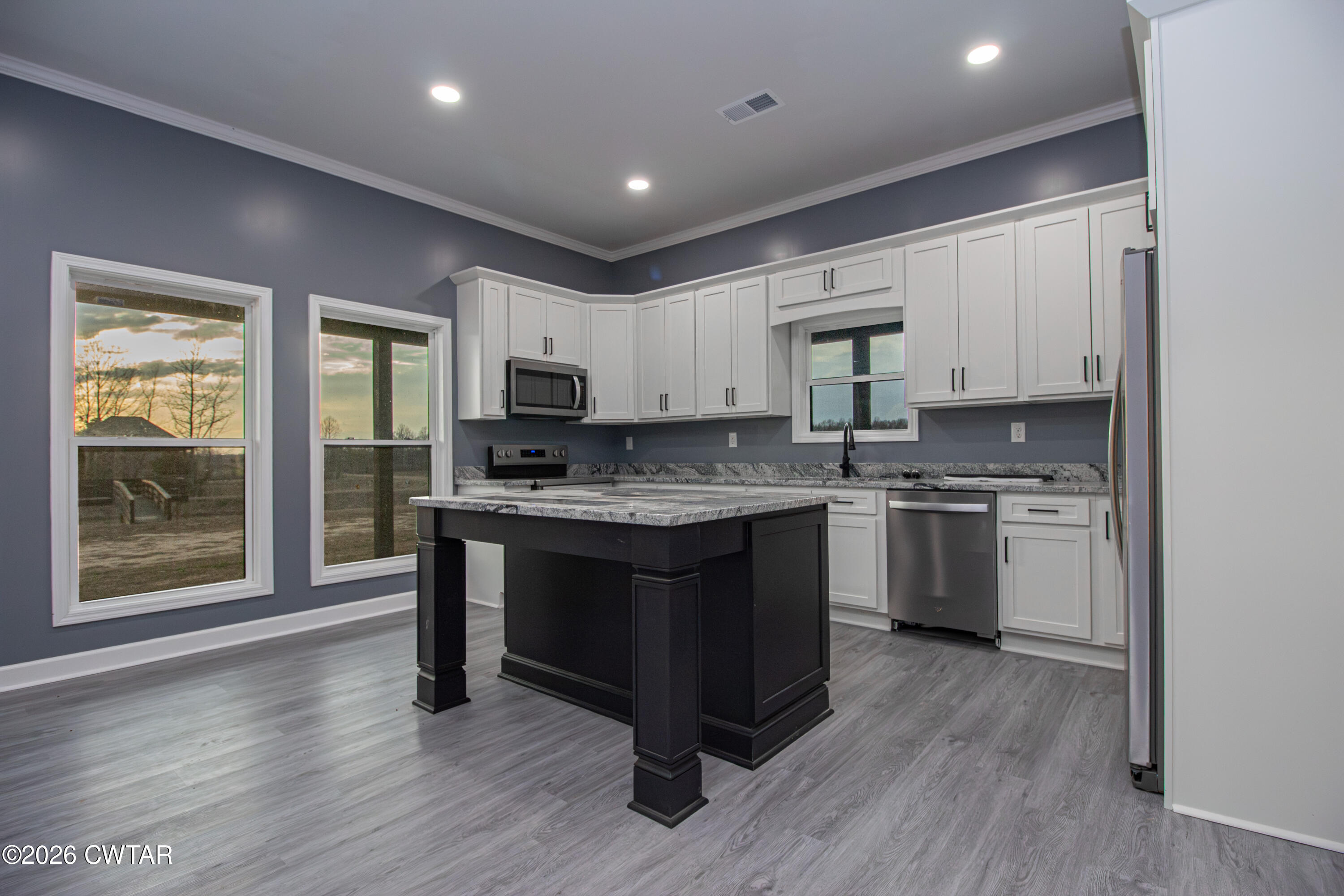 6523 Alamo Gadsden Road Gadsden, TN 38337 - Photo 11 of 25 a kitchen with granite countertop a stove top oven sink and cabinets