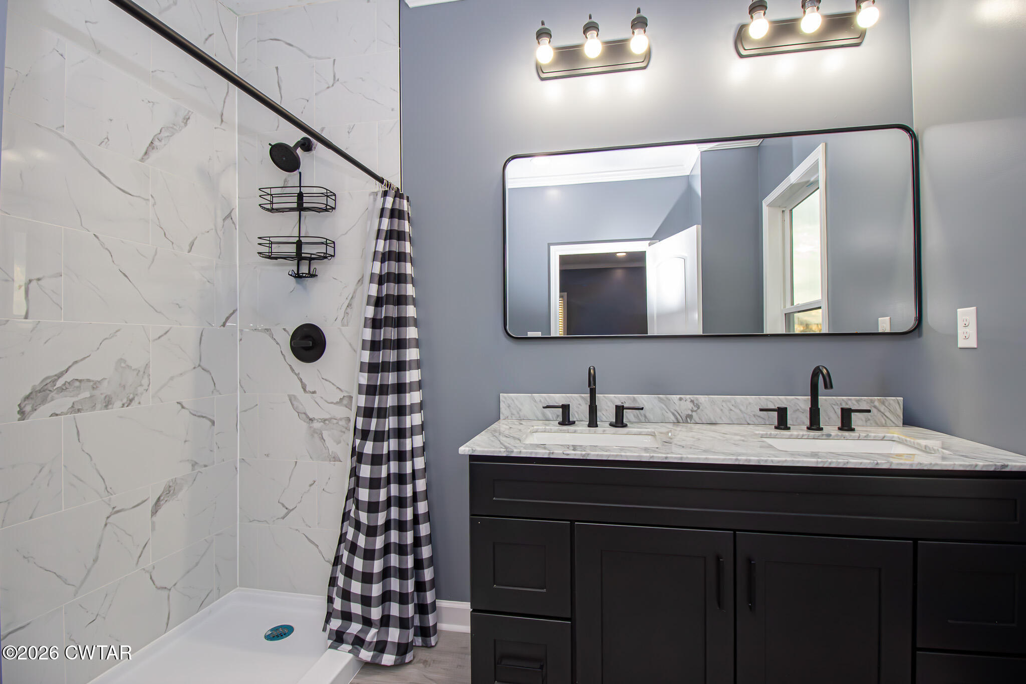 6523 Alamo Gadsden Road Gadsden, TN 38337 - Photo 14 of 25 a bathroom with a sink a mirror a vanity and a shower