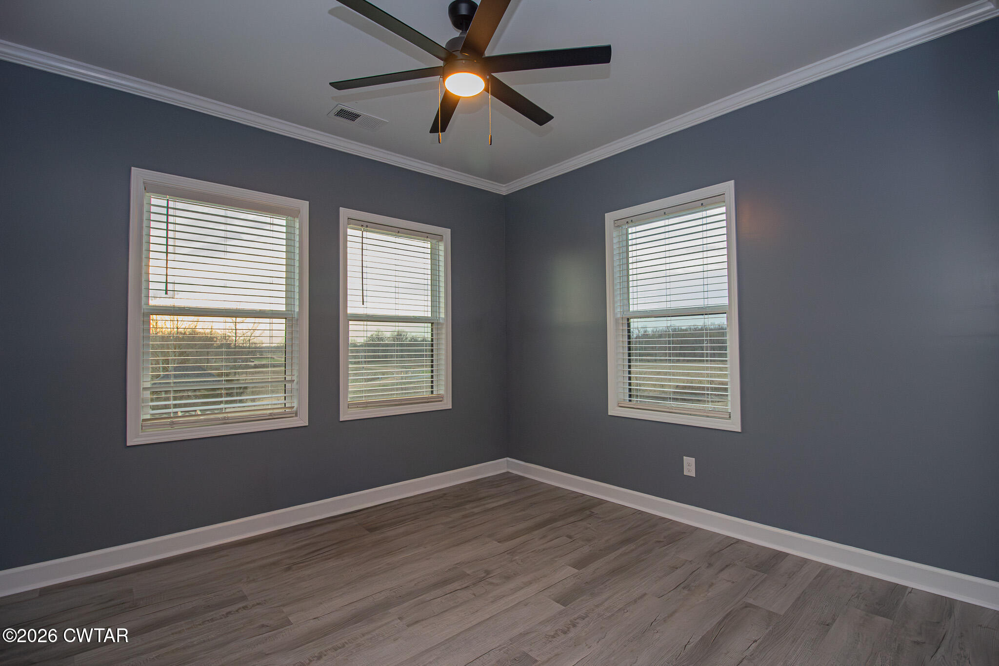 6523 Alamo Gadsden Road Gadsden, TN 38337 - Photo 16 of 25 a view of an empty room with a window and wooden floor