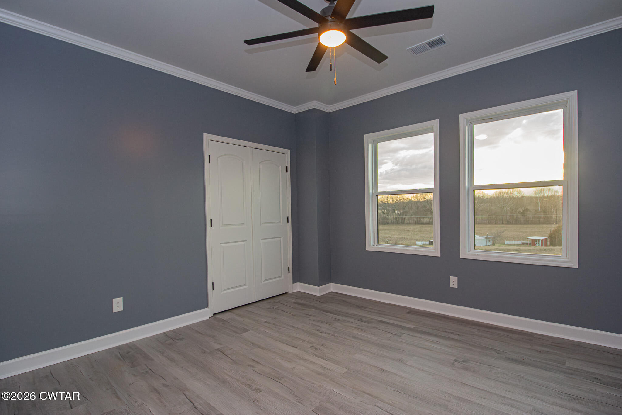 6523 Alamo Gadsden Road Gadsden, TN 38337 - Photo 17 of 25 an empty room with wooden floor and windows