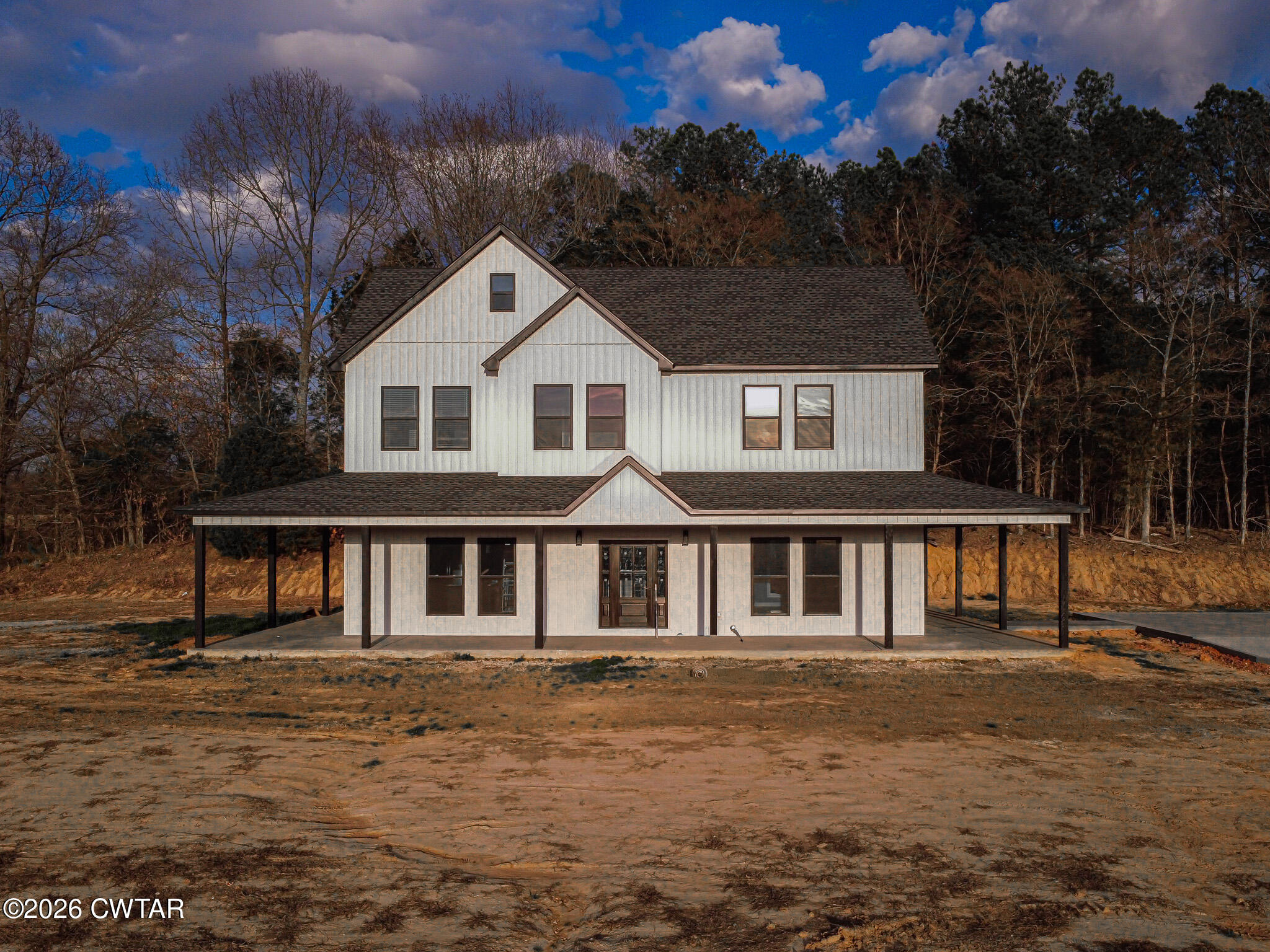 6523 Alamo Gadsden Road Gadsden, TN 38337 - Photo 2 of 25 a front view of a house with a garden and trees