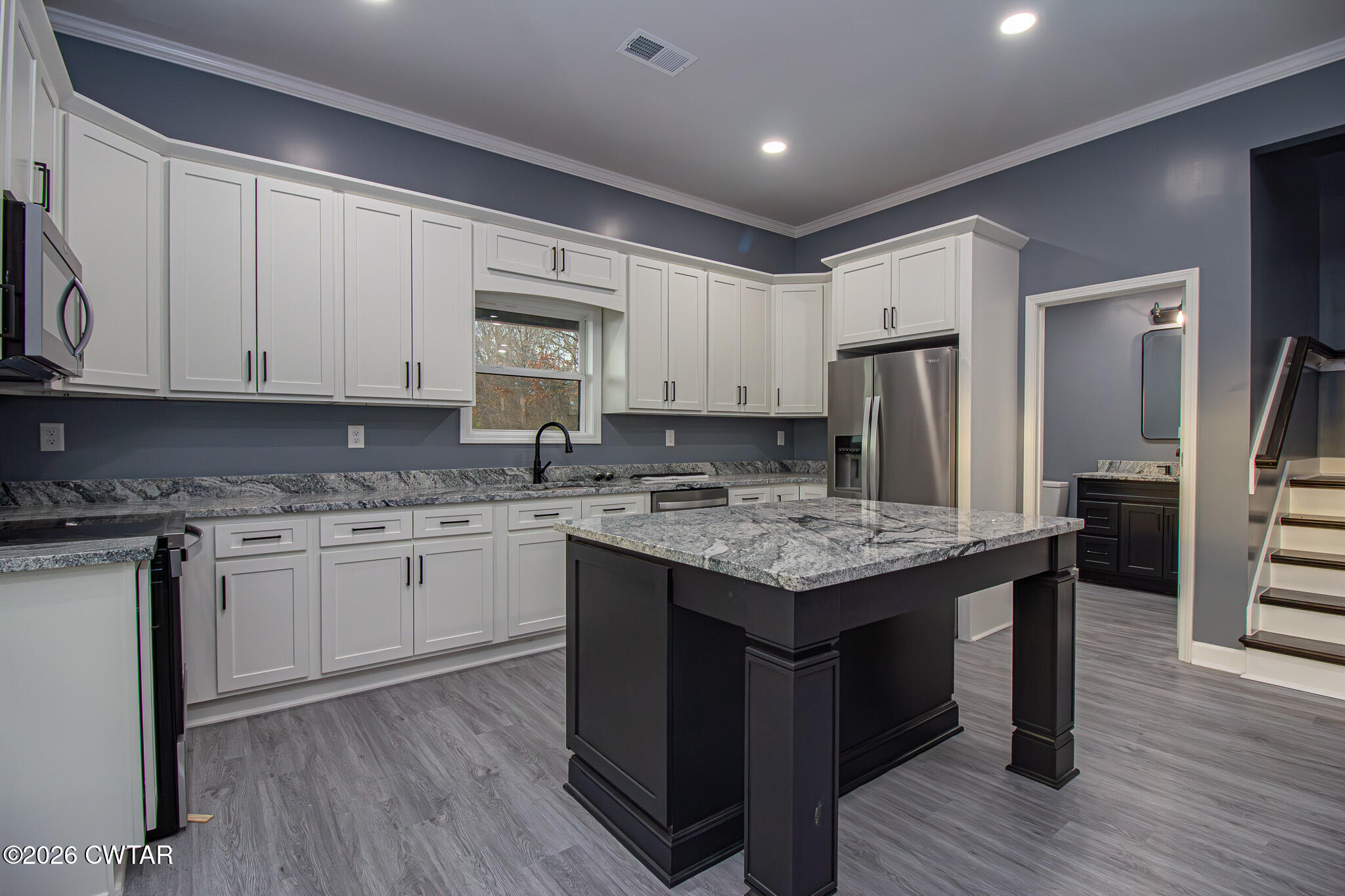 6523 Alamo Gadsden Road Gadsden, TN 38337 - Photo 9 of 25 a kitchen with granite countertop cabinets stainless steel appliances and wooden floor