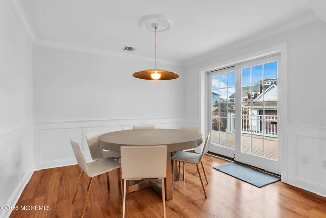 a view of a dining room with furniture and wooden floor