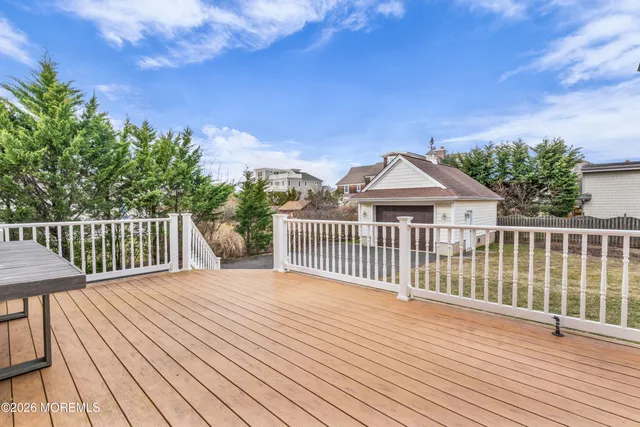 a view of a wooden deck and a yard