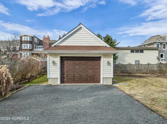 a view of a house with a yard and garage