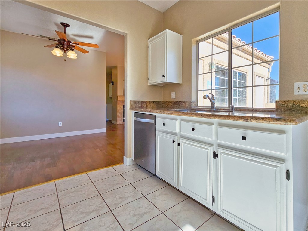 1851 Hillpointe Road, Unit 2124 Henderson, NV 89074 - Photo 11 of 24 Kitchen featuring a sink, white cabinets, stainless steel dishwasher, ceiling fan, and light tile patterned flooring