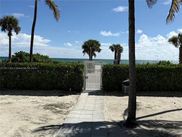 a view of swimming pool with outdoor seating and palm tree