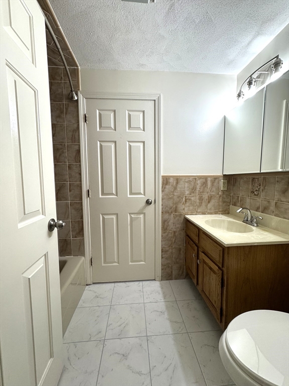 224 Park Street, Unit C8 Stoneham, MA 02180 - Photo 13 of 18 a bathroom with a sink a toilet and shower