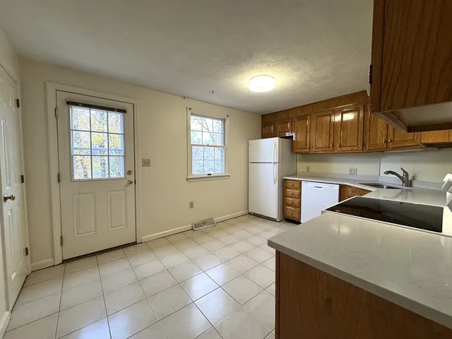 a kitchen that has a sink and a stove in it