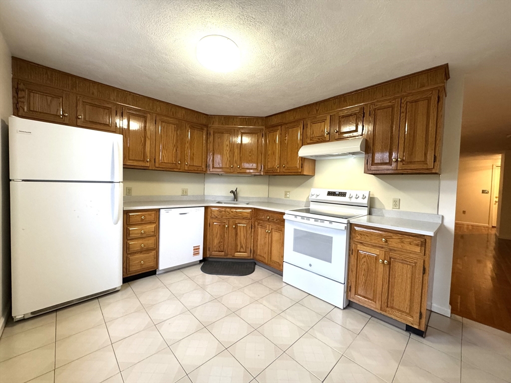 224 Park Street, Unit C8 Stoneham, MA 02180 - Photo 2 of 18 a kitchen with cabinets oven and a sink