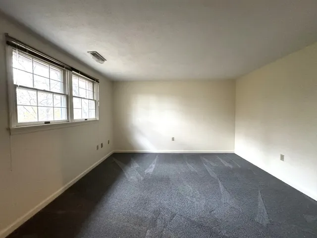an empty room with a empty space and windows
