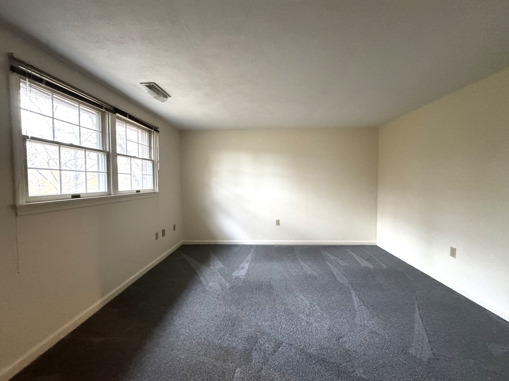 224 Park Street, Unit C8 Stoneham, MA 02180 - Photo 7 of 18 an empty room with a empty space and windows