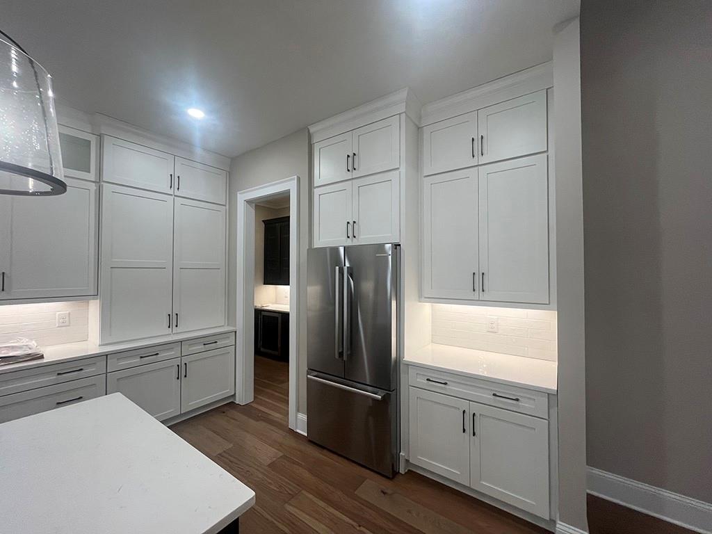 711 Hornage Road Ball Ground, GA 30107 - Photo 11 of 61 a kitchen with white cabinets and stainless steel appliances