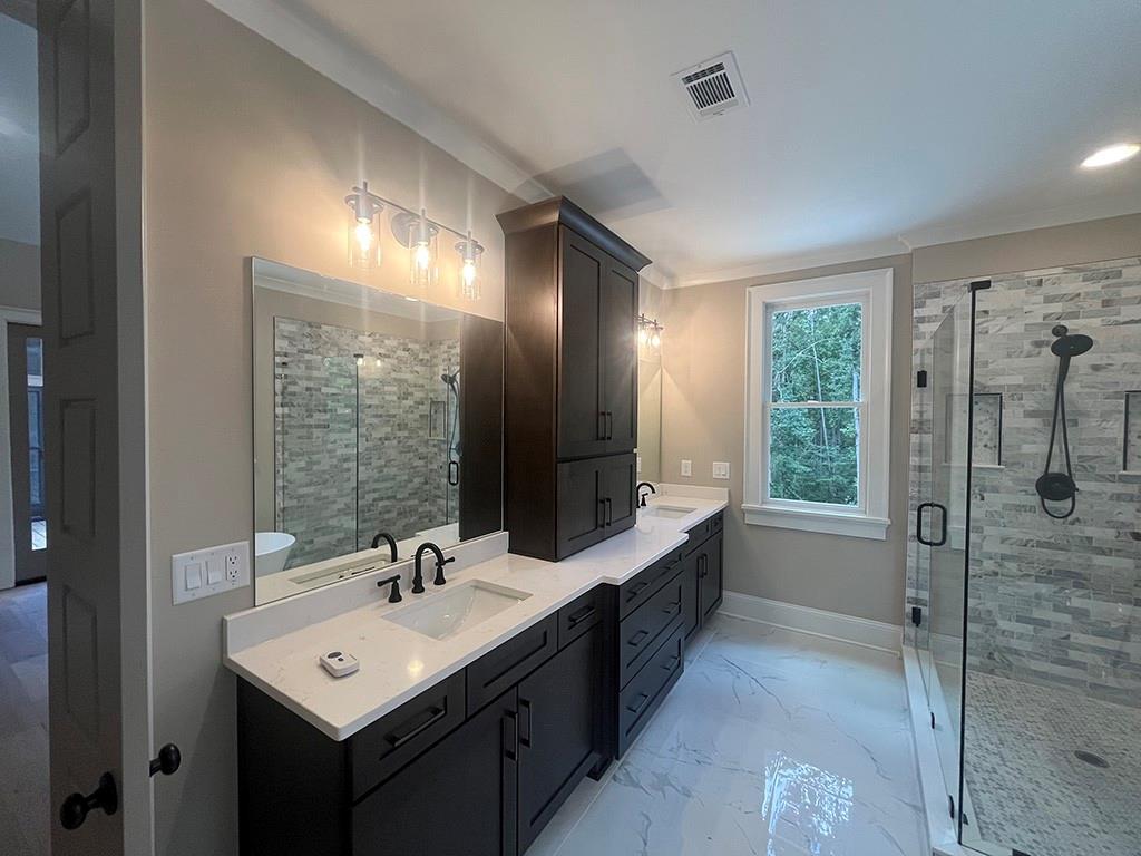 711 Hornage Road Ball Ground, GA 30107 - Photo 18 of 61 a bathroom with a double vanity sink mirror and shower