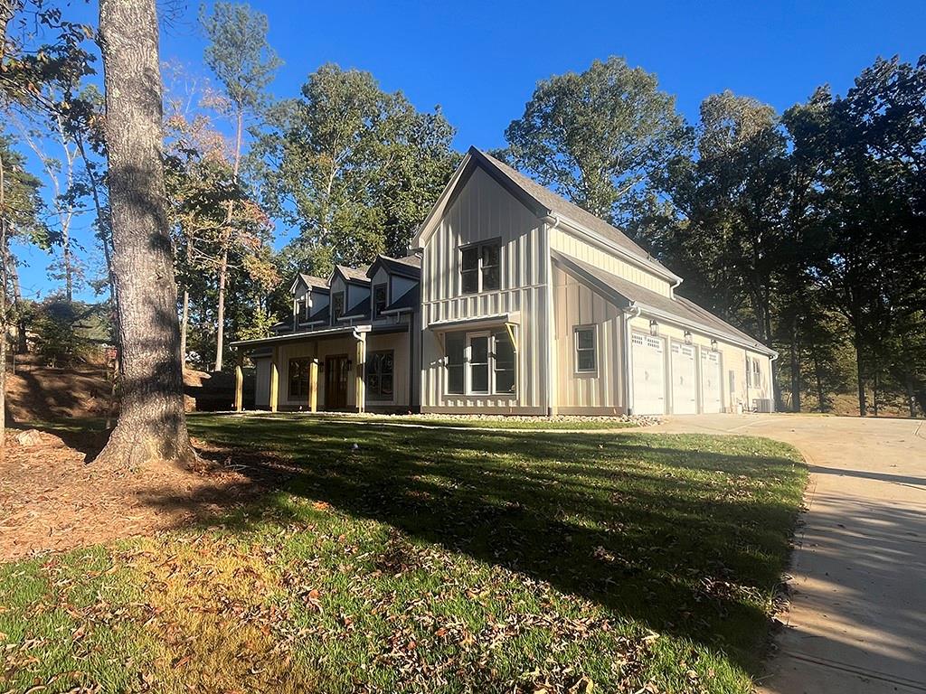 711 Hornage Road Ball Ground, GA 30107 - Photo 3 of 61 a front view of a house with a yard