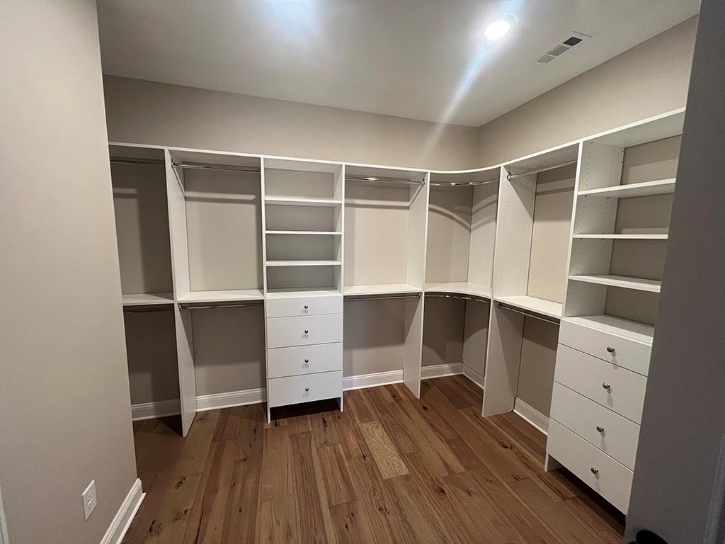 711 Hornage Road Ball Ground, GA 30107 - Photo 42 of 61 a room with walk in closet and wooden floor