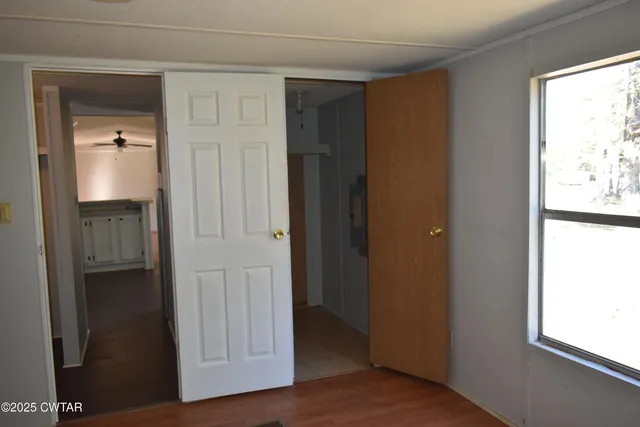 a view of a backyard with lawn chairs and plants