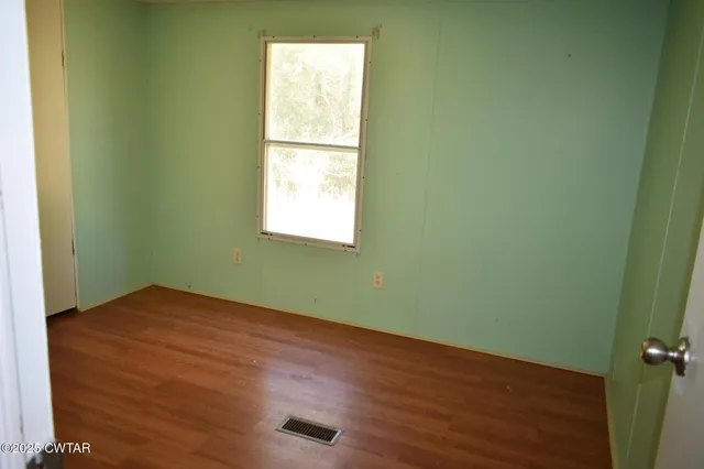 a view of a dining room with furniture a chandelier and window