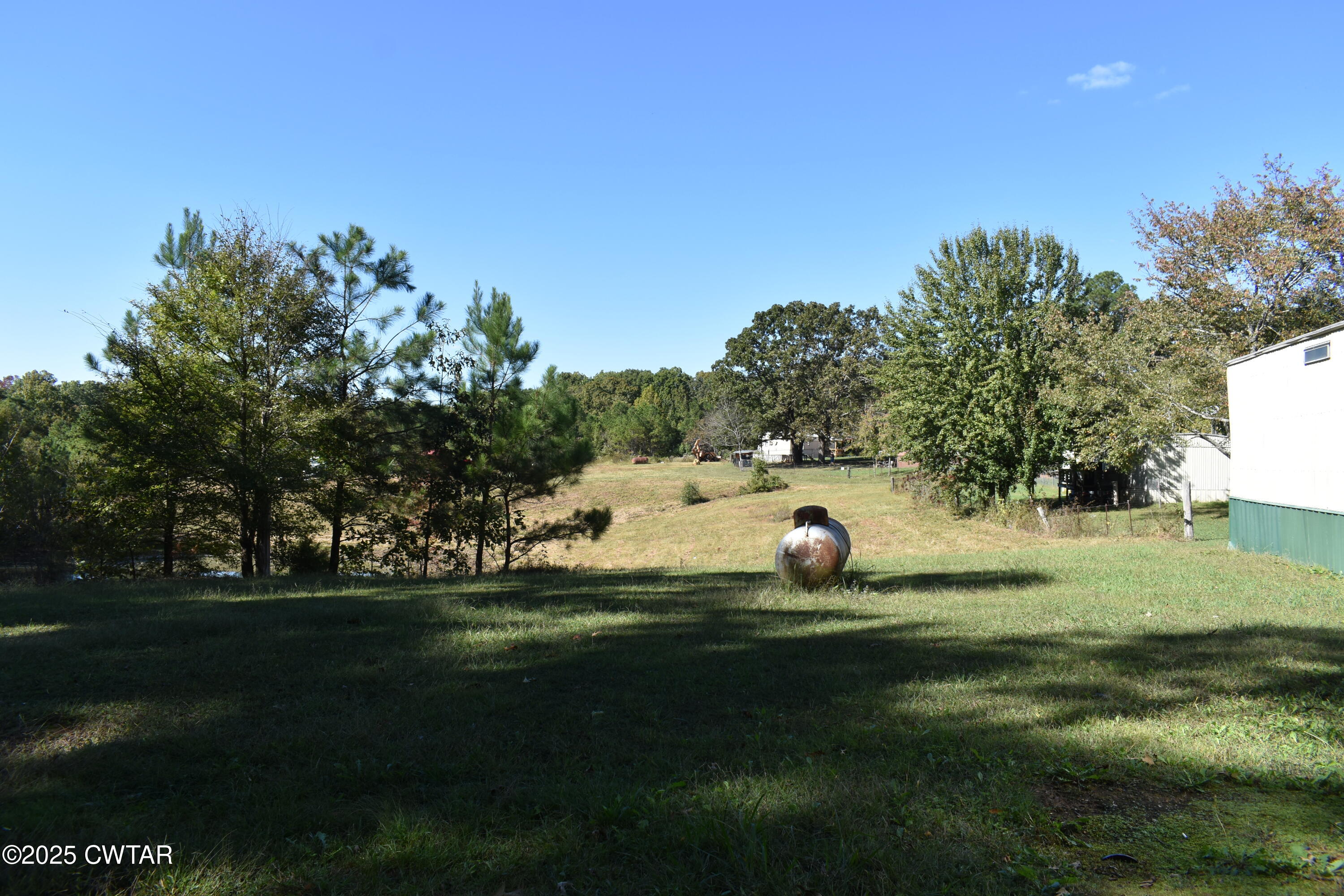825 Verles King Road Medon, TN 38356 - Photo 88 of 91 a backyard of a house with lots of green space and outdoor seating