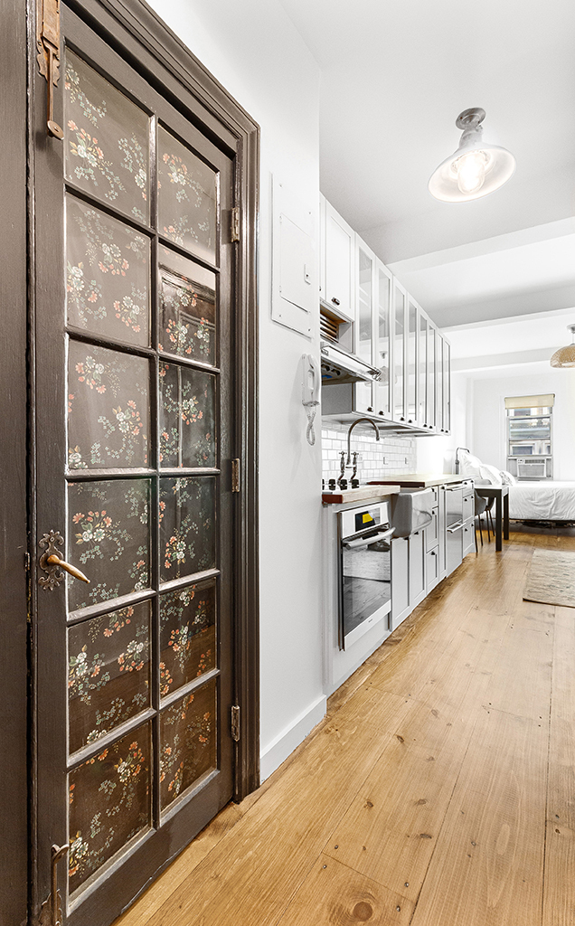 310 Riverside Drive, Unit 1110 Manhattan, NY 10025 - Photo 13 of 18 a kitchen with stainless steel appliances granite countertop a refrigerator and cabinets