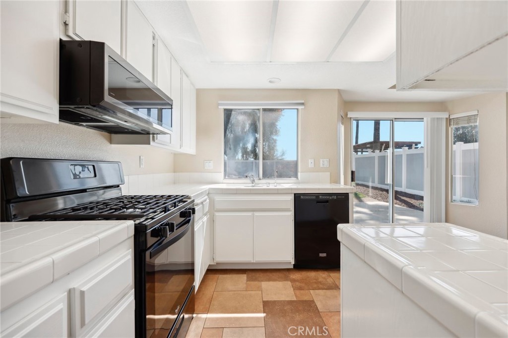 26658 Caravan Circle Corona, CA 92883 - Photo 11 of 50 a kitchen with a sink stove and microwave