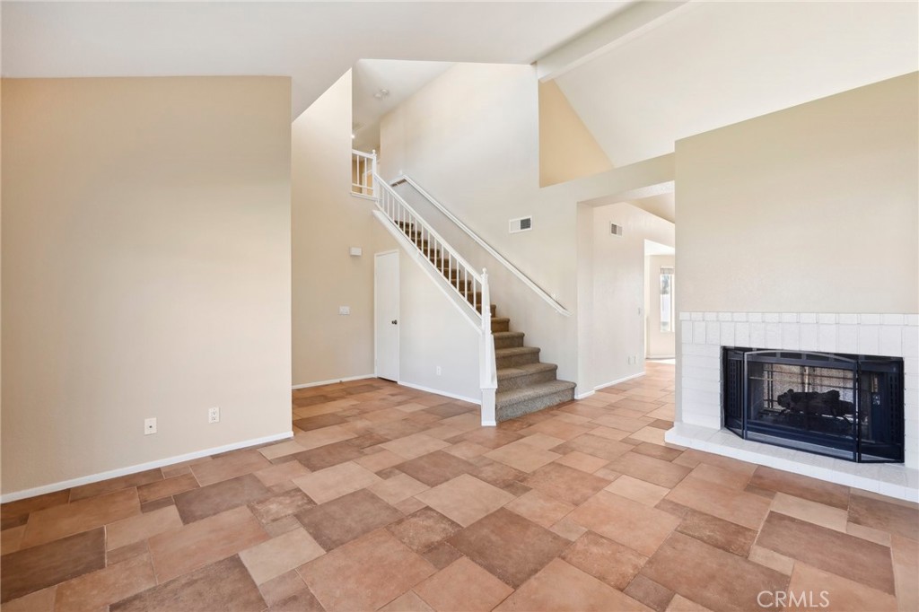 26658 Caravan Circle Corona, CA 92883 - Photo 13 of 50 a view of an empty room with wooden floor and a fireplace
