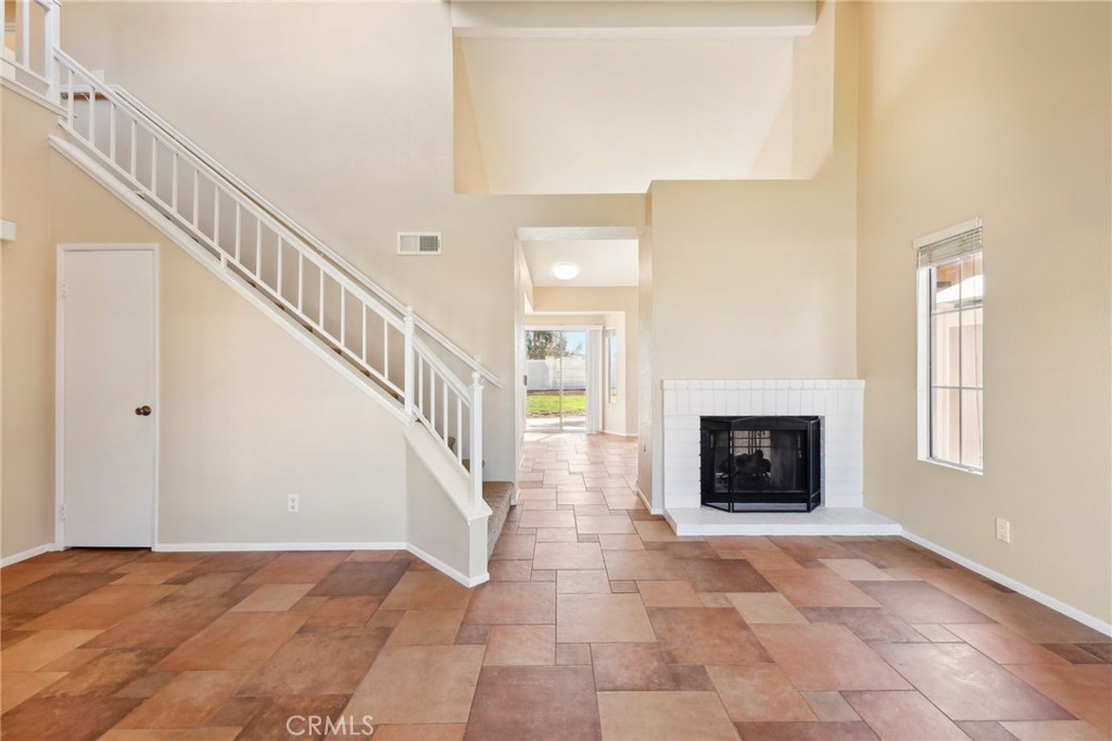 26658 Caravan Circle Corona, CA 92883 - Photo 14 of 50 a view of an empty room with fireplace and a window