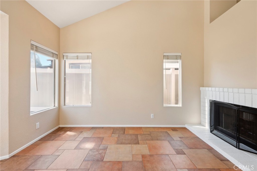 26658 Caravan Circle Corona, CA 92883 - Photo 17 of 50 a view of an empty room with a fireplace and a window