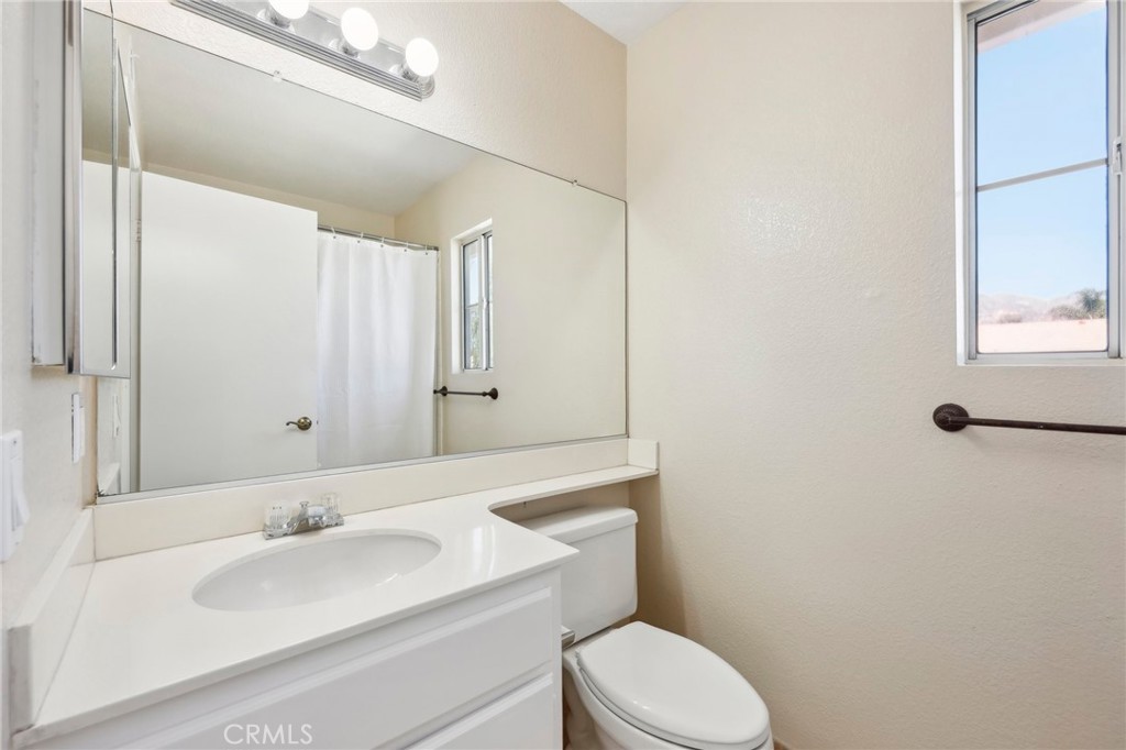 26658 Caravan Circle Corona, CA 92883 - Photo 19 of 50 a bathroom with a toilet sink and mirror