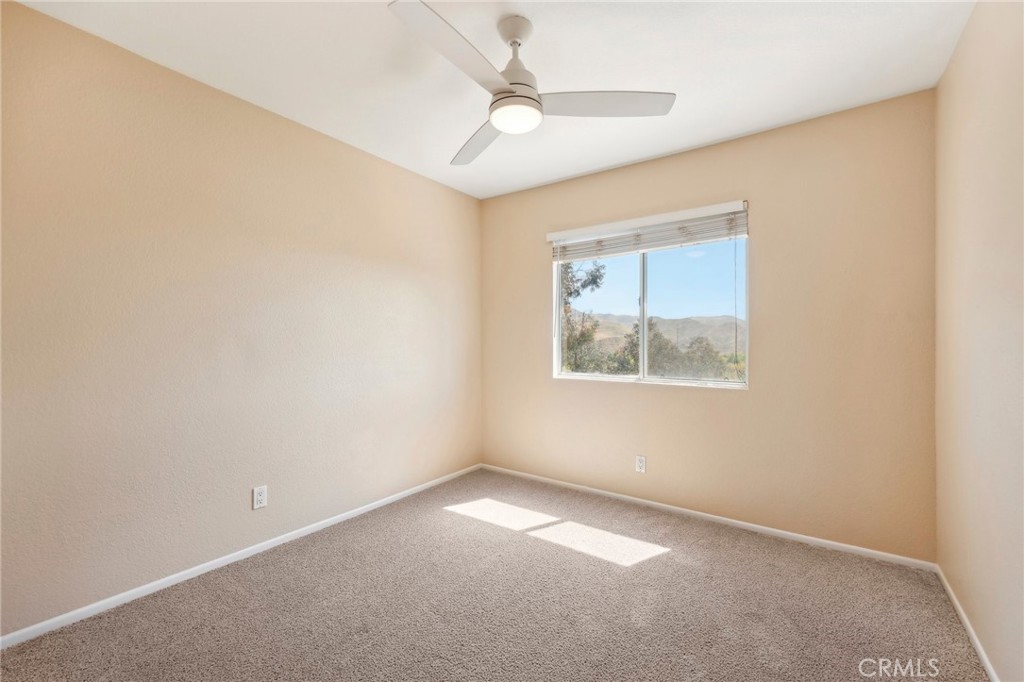 26658 Caravan Circle Corona, CA 92883 - Photo 29 of 50 an empty room with a window and a fan