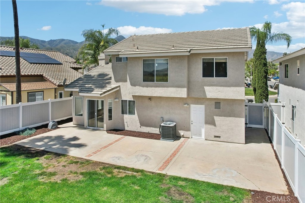 26658 Caravan Circle Corona, CA 92883 - Photo 40 of 50 a view of a white house with a yard and potted plants