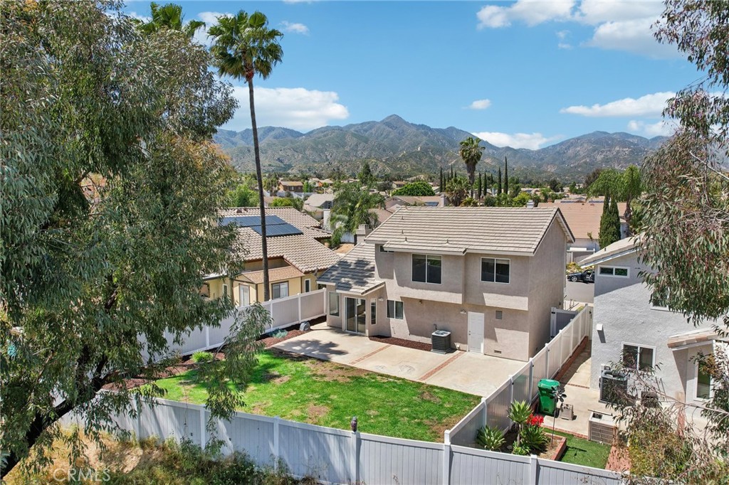 26658 Caravan Circle Corona, CA 92883 - Photo 42 of 50 a front view of a house with a yard and mountain view