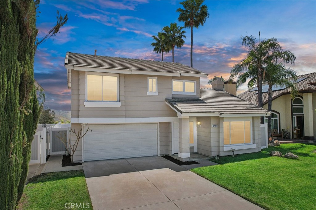26658 Caravan Circle Corona, CA 92883 - Photo 7 of 50 a front view of a house with a garden and trees