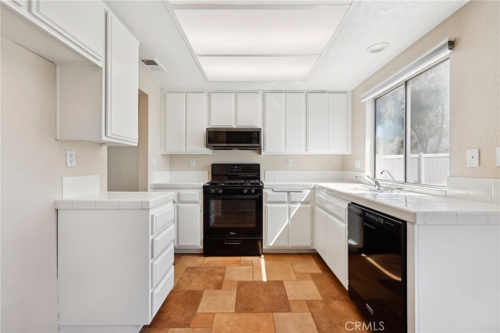 26658 Caravan Circle Corona, CA 92883 - Photo 10 of 50 a kitchen with a sink stove and refrigerator