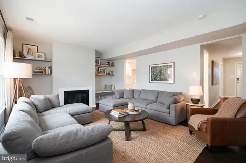 a living room with furniture a rug and a window