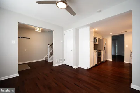 a view of empty room with wooden floor