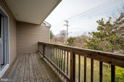 a view of a balcony with wooden floor
