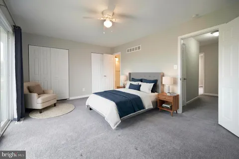 a bedroom with a bed couch and a window