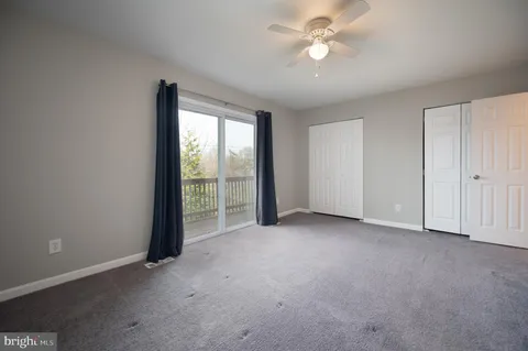 an empty room with chandelier fan