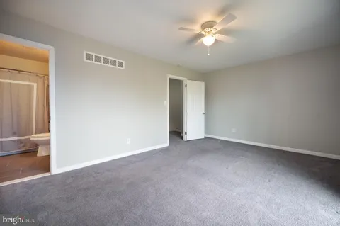 a view of an empty room with a ceiling fan