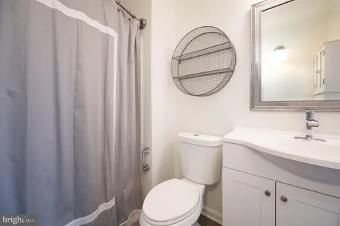a bathroom with a toilet a sink and a mirror