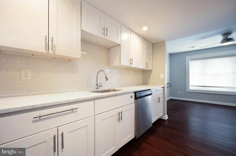 a kitchen with sink cabinets and wooden floor