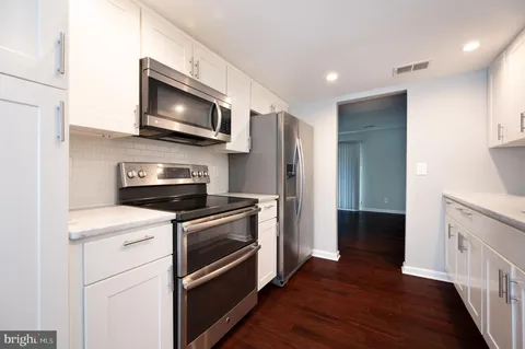 a kitchen with a refrigerator stove and microwave