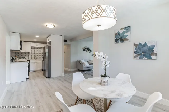 a bathroom with a bathtub shower sink vanity mirror and toilet