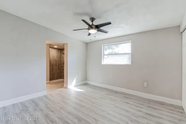 a view of an empty room and wooden floor