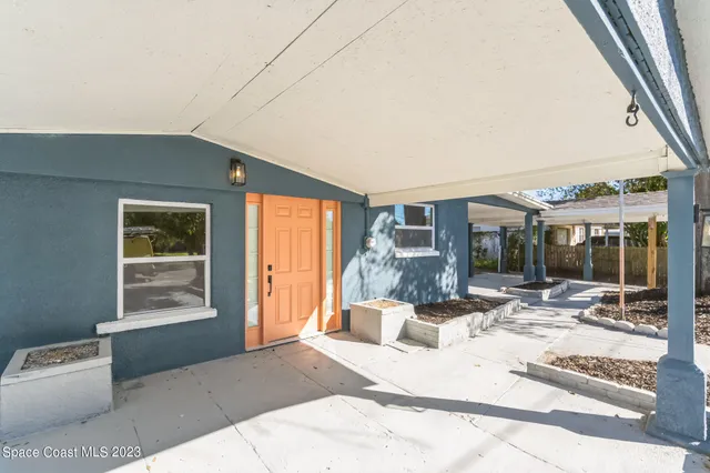 a bedroom with furniture and large windows